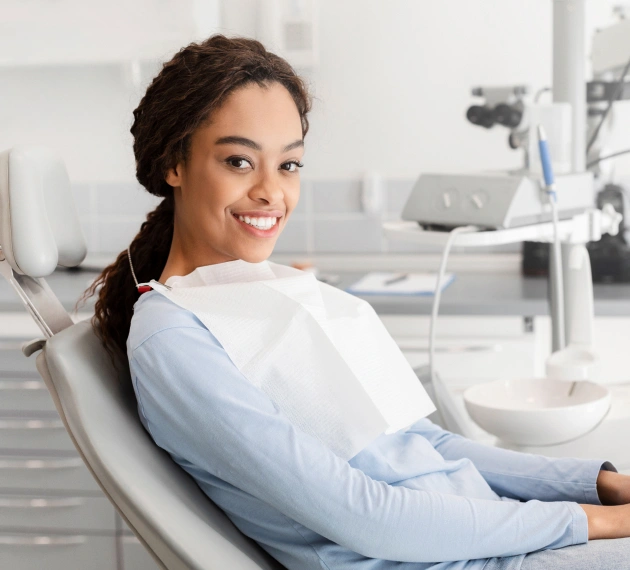 Smiling woman relaxing in dental chair at modern dentistry office